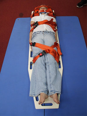 Physio Team Practicing Spinal Board Straps